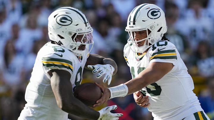 Oct 20, 2024; Green Bay, Wisconsin, USA;  Green Bay Packers quarterback Jordan Love (10) hands the football off to running back Josh Jacobs (8) during the third quarter against the Houston Texans at Lambeau Field. Mandatory Credit: Jeff Hanisch-Imagn Images