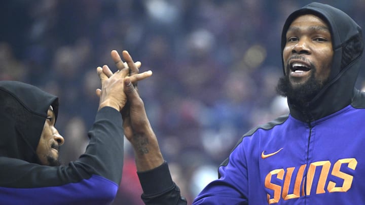 Jan 20, 2025; Cleveland, Ohio, USA; Phoenix Suns forward Kevin Durant (right) reacts during introductions before a game against the Cleveland Cavaliers at Rocket Mortgage FieldHouse. Mandatory Credit: David Richard-Imagn Images