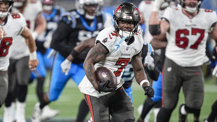 Dec 1, 2024; Charlotte, North Carolina, USA; Tampa Bay Buccaneers running back Bucky Irving (7)  runs for yardage against the Carolina Panthers during the second half at Bank of America Stadium. Mandatory Credit: Jim Dedmon-Imagn Images