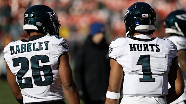 Dec 22, 2024; Landover, Maryland, USA; Philadelphia Eagles running back Saquon Barkley (26) and Eagles quarterback Jalen Hurts (1) stand on the field during warmup prior to the game against the Washington Commanders at Northwest Stadium. Mandatory Credit: Geoff Burke-Imagn Images
