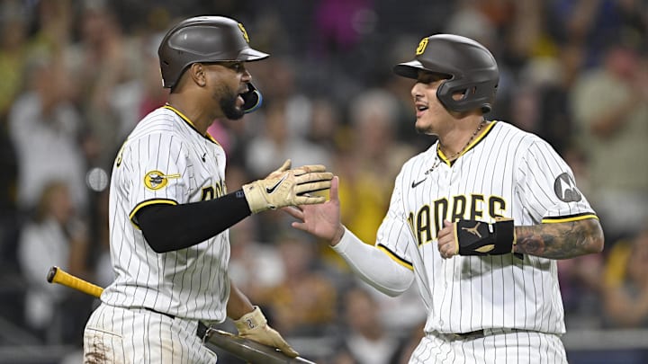Aug 19, 2025; San Diego, California, USA; San Diego Padres third baseman Manny Machado (13) is congratulated by Xander Bogaerts (2) after scoring during the fifth inning at Petco Park. Mandatory Credit: Denis Poroy-Imagn Images