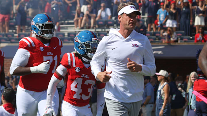 Oct 11, 2025; Oxford, Mississippi, USA; Mississippi Rebels head coach Lane Kiffin leads his team out of the tunnel prior to the game against the Washington State Cougars at Vaught-Hemingway Stadium. Mandatory Credit: Petre Thomas-Imagn Images
