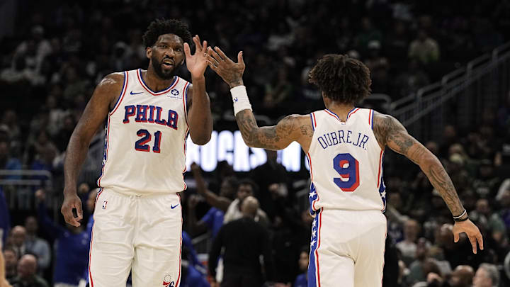 Oct 26, 2023; Milwaukee, Wisconsin, USA;  Philadelphia 76ers center Joel Embiid (21) high fives forward Kelly Oubre Jr. (9) during the second quarter against the Milwaukee Bucks at Fiserv Forum. Mandatory Credit: Jeff Hanisch-Imagn Images