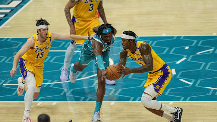 Jan 27, 2025; Charlotte, North Carolina, USA; Charlotte Hornets center Mark Williams (5) tries for a steal from Los Angeles Lakers forward Jarred Vanderbilt (2) during the second half at the Spectrum Center. Mandatory Credit: Jim Dedmon-Imagn Images