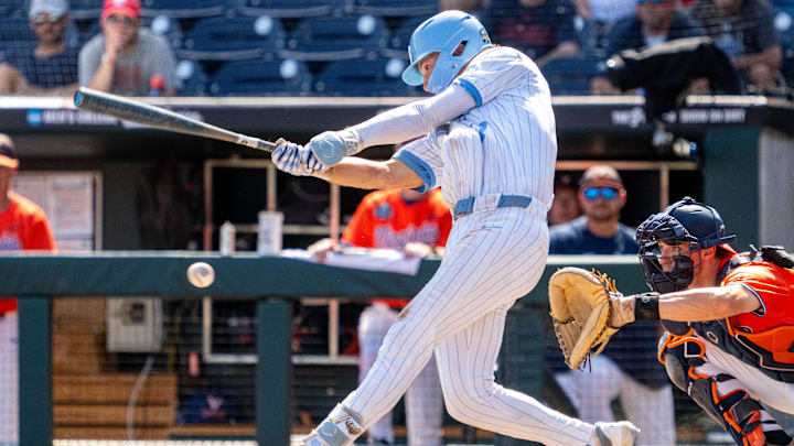 Jun 14, 2024; Omaha, NE, USA; North Carolina Tar Heels center fielder Vance Honeycutt (7) hits a walk off RBI single during the ninth inning against the Virginia Cavaliers at Charles Schwab Filed Omaha. Mandatory Credit: Dylan Widger-USA TODAY Sports