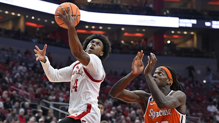 Mar 3, 2026; Louisville, Kentucky, USA; Louisville Cardinals guard Adrian Wooley (14) shoots against Syracuse Orange forward William Kyle III (42) during the first half at KFC Yum! Center. Mandatory Credit: Jamie Rhodes-Imagn Images Mar 3, 2026; Louisville, Kentucky, USA; Louisville Cardinals guard Adrian Wooley (14) shoots against Syracuse Orange forward William Kyle III (42) during the first half at KFC Yum! Center. Mandatory Credit: Jamie Rhodes-Imagn Images
