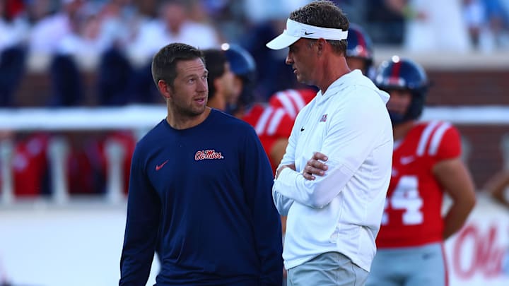 Aug 30, 2025; Oxford, Mississippi, USA; Mississippi Rebels head coach Lane Kiffin (right) talks with offensive coordinator Charlie Weis Jr. during warm ups prior to the game against the Georgia State Panthers at Vaught-Hemingway Stadium. Mandatory Credit: Petre Thomas-Imagn Images