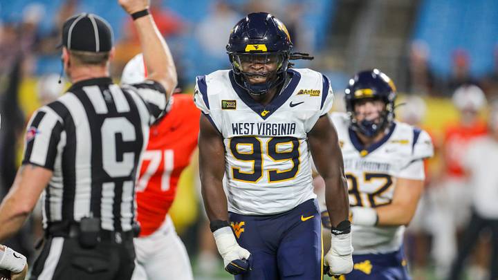 Sep 19, 2026; Charlotte, North Carolina, USA; West Virginia Mountaineers defensive end David Afogho (99) celebrates after sacking Virginia Cavaliers quarterback Beau Pribula (7) during the second quarter at Bank of America Stadium. Mandatory Credit: Ben Queen-Imagn Images Sep 19, 2026; Charlotte, North Carolina, USA; West Virginia Mountaineers defensive end David Afogho (99) celebrates after sacking Virginia Cavaliers quarterback Beau Pribula (7) during the second quarter at Bank of America Stadium. Mandatory Credit: Ben Queen-Imagn Images