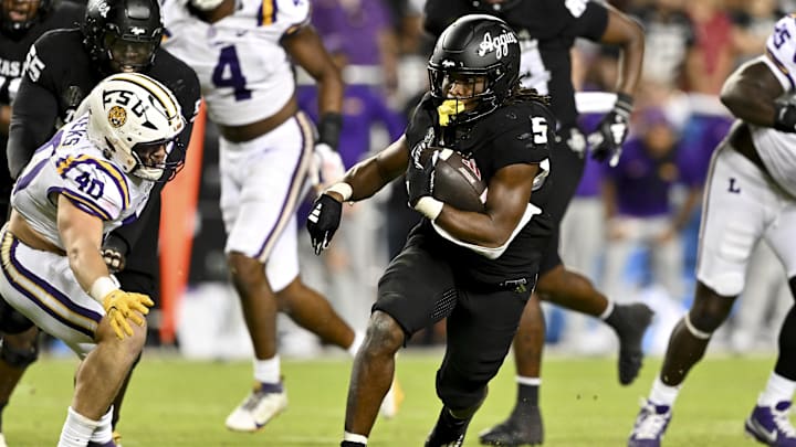 Oct 26, 2024; College Station, Texas, USA; Texas A&M Aggies running back Amari Daniels (5) runs the ball in the fourth quarter against the LSU Tigers at Kyle Field. Mandatory Credit: Maria Lysaker-Imagn Images. 