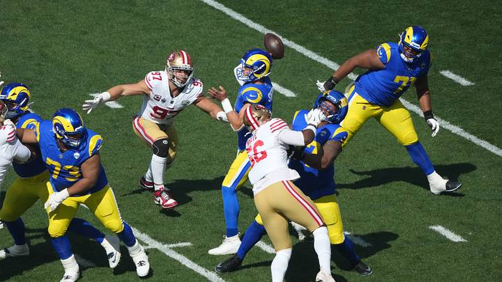 Sep 11, 2026; Melbourne, Victoria, Australia; Los Angeles Rams quarterback Matthew Stafford (9) throws the ball under pressure from San Francisco 49ers defensive end Nick Bosa (97) and defensive end Keion White (56) in the first quarter during the 2026 NFL Melbourne Game at Melbourne Cricket Ground. Mandatory Credit: Kirby Lee-Imagn Images