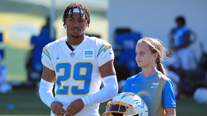 Los Angeles Chargers cornerback Tarheeb Still walks with a female fan during training camp at The Bolt. 