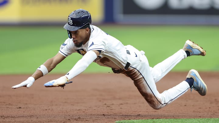 Apr 6, 2026; St. Petersburg, Florida, USA; Tampa Bay Rays center fielder Chandler Simpson (14) steals third base against the Chicago Cubs in the second inning at Tropicana Field. Mandatory Credit: Nathan Ray Seebeck-Imagn Images