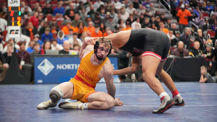 Carlisle's Asa Hemsted wrestles Damarion Ross of Fort Dodge in the state finals last year.