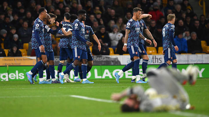 Arsenal celebrate with the stricken Jose Sa grounded