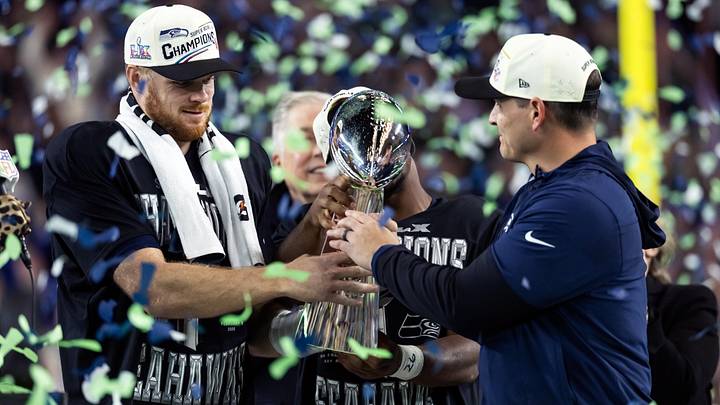 Seattle Seahawks head coach Mike MacDonald and quarterback Sam Darnold celebrate with the Vince Lombardi trophy.