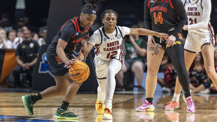 Mar 28, 2025; Birmingham, AL, USA; South Carolina Gamecocks guard MiLaysia Fulwiley (12) goes for a steal against Maryland Terrapins guard Sarah Te-Biasu (1) during the first half of a Sweet 16 NCAA Tournament basketball game at Legacy Arena. Mandatory Credit: Vasha Hunt-Imagn Images