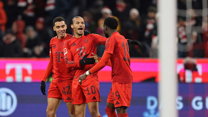 Bayern Munich stars Jamal Musiala, Leroy Sane, and Alphonso Davies celebrate against RB Leipzig.