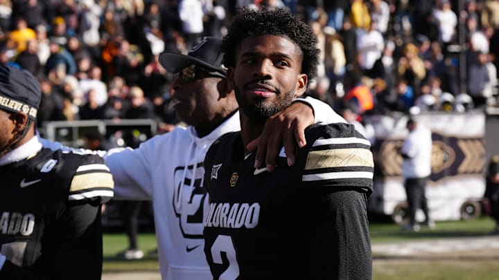 Nov 29, 2024; Boulder, Colorado, USA; Colorado Buffaloes quarterback Shedeur Sanders (2) and head coach Deion Sanders ifollowing the win over the Oklahoma State Cowboys at Folsom Field.  