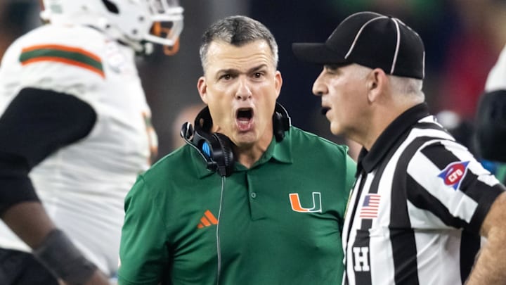 Jan 8, 2026; Glendale, AZ, USA; Miami Hurricanes head coach Mario Cristobal argues with a referee against the Mississippi Rebels during the 2026 Fiesta Bowl and semifinal game of the College Football Playoff at State Farm Stadium. Mandatory Credit: Mark J. Rebilas-Imagn Images Jan 8, 2026; Glendale, AZ, USA; Miami Hurricanes head coach Mario Cristobal argues with a referee against the Mississippi Rebels during the 2026 Fiesta Bowl and semifinal game of the College Football Playoff at State Farm Stadium. Mandatory Credit: Mark J. Rebilas-Imagn Images