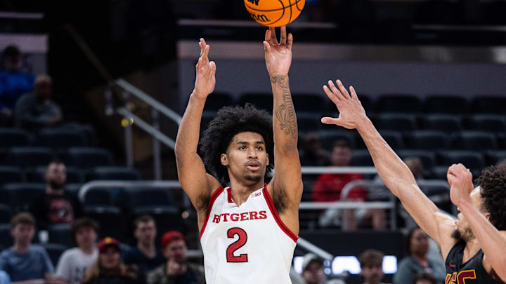 Mar 12, 2025; Indianapolis, IN, USA; Rutgers Scarlet Knights guard Dylan Harper (2) shoots the ball while USC Trojans guard Desmond Claude (1) defends in the second half at Gainbridge Fieldhouse. Mandatory Credit: Trevor Ruszkowski-Imagn Images