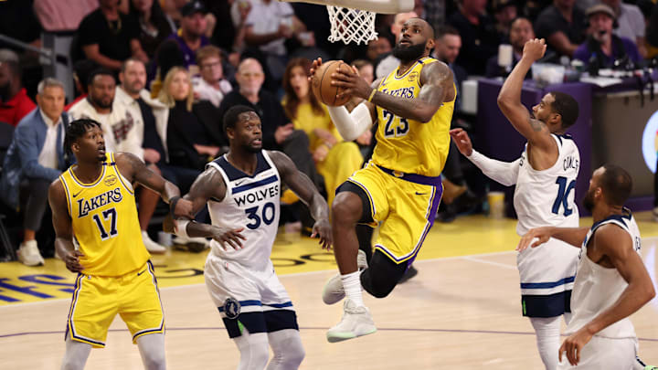 Apr 22, 2025; Los Angeles, California, USA: Los Angeles Lakers forward LeBron James (23) goes to the basket between Minnesota Timberwolves forward Julius Randle (30) and guard Mike Conley (10) during the fourth quarter of game two of first round for the 2024 NBA Playoffs at Crypto.com Arena. Mandatory Credit: Kiyoshi Mio-Imagn Images