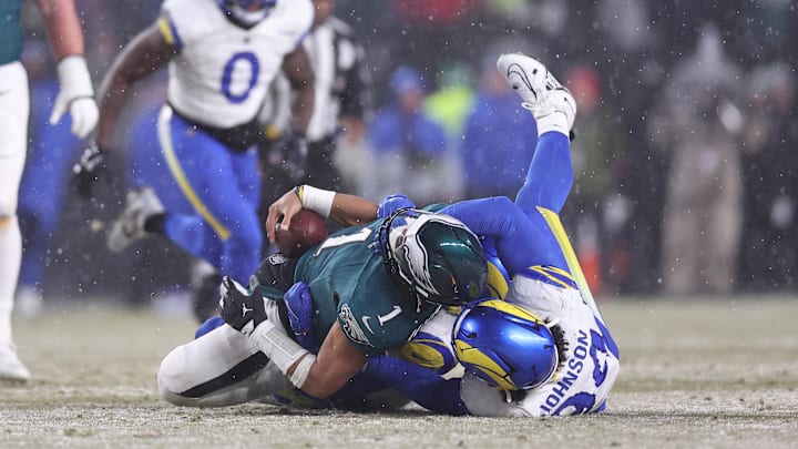 Jan 19, 2025; Philadelphia, Pennsylvania, USA; Philadelphia Eagles quarterback Jalen Hurts (1) is sacked by Los Angeles Rams defensive end Desjuan Johnson (94) and Rams safety Jaylen McCollough (39) in the third quarter in a 2025 NFC divisional round game at Lincoln Financial Field. Jan 19, 2025; Philadelphia, Pennsylvania, USA; Philadelphia Eagles quarterback Jalen Hurts (1) is sacked by Los Angeles Rams defensive end Desjuan Johnson (94) and Rams safety Jaylen McCollough (39) in the third quarter in a 2025 NFC divisional round game at Lincoln Financial Field.