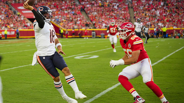 Aug 22, 2025; Kansas City, Missouri, USA; Chicago Bears quarterback Caleb Williams (18) throws a pass against Kansas City Chiefs defensive end George Karlaftis (56) during the first half at GEHA Field at Arrowhead Stadium. Mandatory Credit: Jay Biggerstaff-Imagn Images
