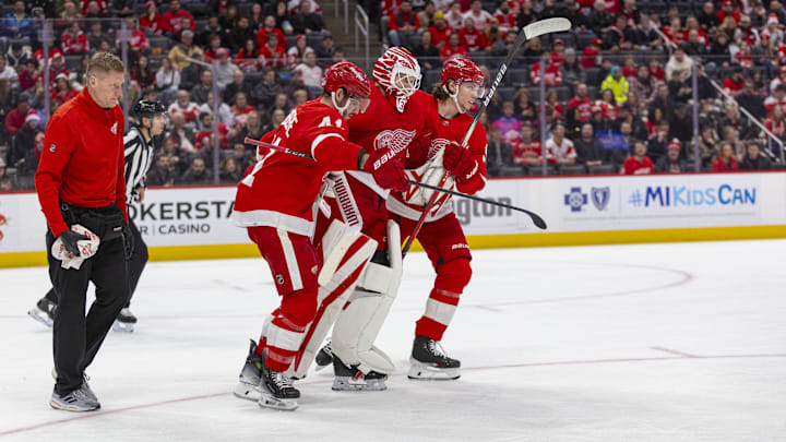 Detroit Red Wings goaltender Ville Husso (35) is helped off the ice after sustaining a lower-body injury