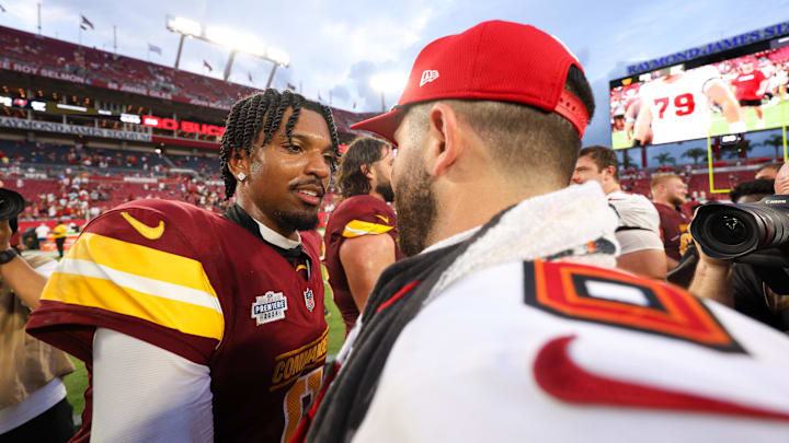 Sep 8, 2024; Tampa, Florida, USA; Washington Commanders quarterback Jayden Daniels (5) greets Tampa Bay Buccaneers quarterback Baker Mayfield (6) after a game at Raymond James Stadium. Mandatory Credit: Nathan Ray Seebeck-Imagn Images