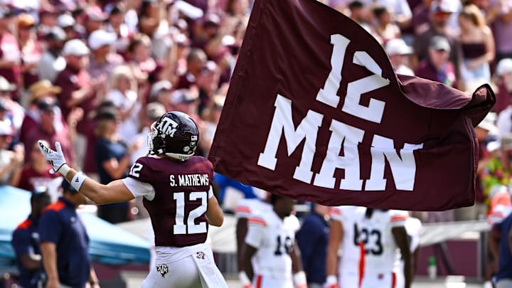 Sep 23, 2023; College Station, Texas, USA; Texas A&M Aggies linebacker Sam Mathews (12) waves the 12th Man flag during pre-game runout against the Auburn Tigers at Kyle Field. Mandatory Credit: Maria Lysaker-Imagn Images