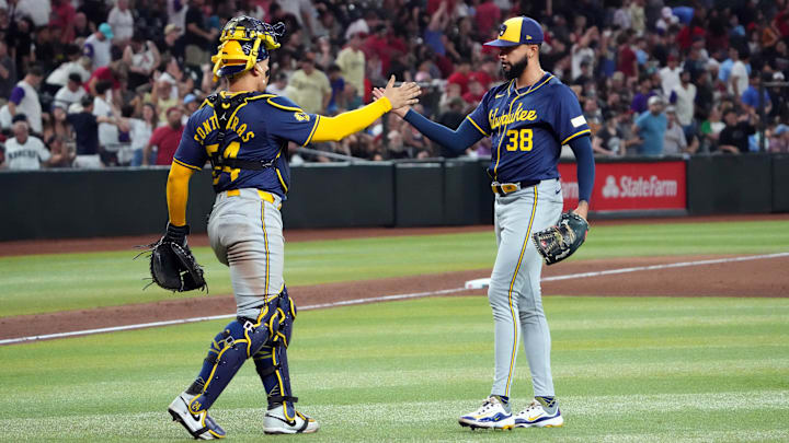Sep 13, 2024; Phoenix, Arizona, USA; Milwaukee Brewers catcher William Contreras (24) and Milwaukee Brewers pitcher Devin Williams (38) slap hands after defeating the Arizona Diamondbacks at Chase Field. Mandatory Credit: Joe Camporeale-Imagn Images