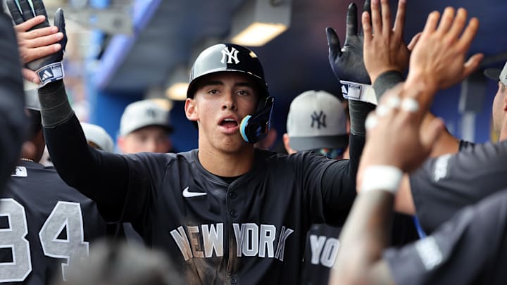 Feb 22, 2025; Dunedin, Florida, USA; New York Yankees shortstop George Lombard Jr. (96) is congratulated after he scored a run during the sixth inning against the Toronto Blue Jays at TD Ballpark. Mandatory Credit: Kim Klement Neitzel-Imagn Images Feb 22, 2025; Dunedin, Florida, USA; New York Yankees shortstop George Lombard Jr. (96) is congratulated after he scored a run during the sixth inning against the Toronto Blue Jays at TD Ballpark. Mandatory Credit: Kim Klement Neitzel-Imagn Images