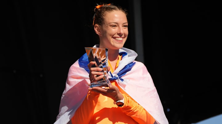 Nov 18, 2023; Charlottesville, VA, USA; Sivan Auerbach of Oklahoma State poses with the Elite 90 award trophy during the NCAA cross country championships at Panorama Farms. Mandatory Credit: Kirby Lee-Imagn Images