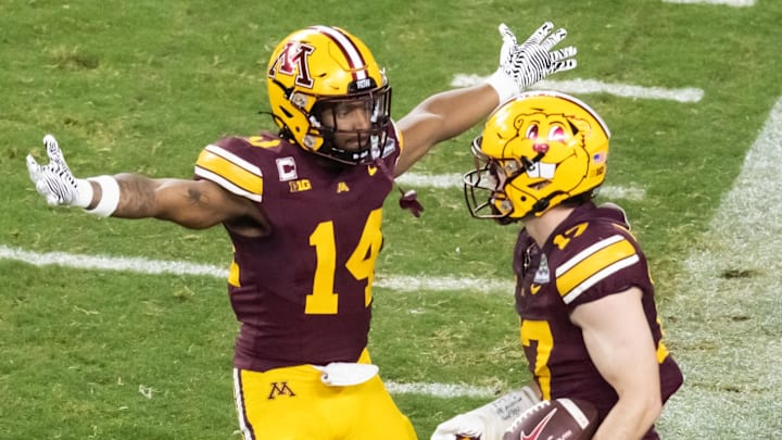 Dec 26, 2025; Phoenix, AZ, USA; Minnesota Golden Gophers defensive back John Nestor (17) celebrates an interception with teammate Kerry Brown (14) against the New Mexico Lobos during the Rate Bowl at Chase Field. Mandatory Credit: Mark J. Rebilas-Imagn Images