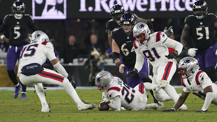 Dec 21, 2025; Baltimore, Maryland, USA;  New England Patriots cornerback Marcus Jones (25)  recovers a fumble during the second half of the game against the Baltimore Ravens at M&T Bank Stadium. Mandatory Credit: James Lang-Imagn Images