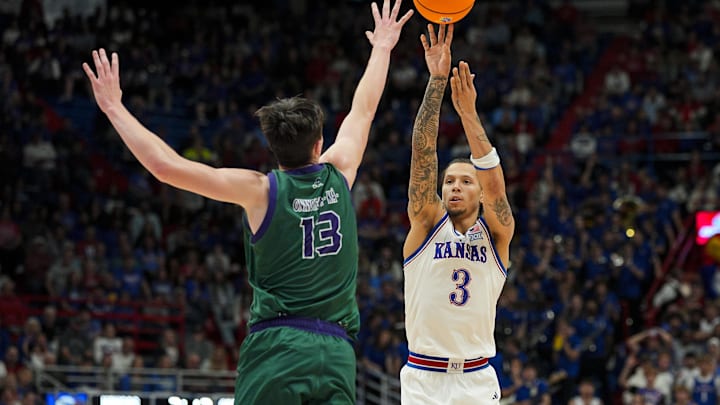 Nov 3, 2025; Lawrence, Kansas, USA; Kansas Jayhawks guard Tre White (3) shoots against Green Bay Phoenix forward Marcus Hall (13) during the second half at Allen Fieldhouse. Mandatory Credit: Jay Biggerstaff-Imagn Images