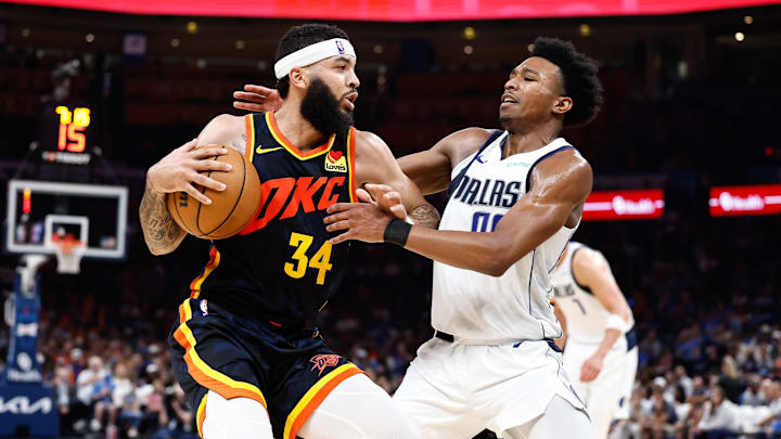 Apr 14, 2024; Oklahoma City, Oklahoma, USA; Oklahoma City Thunder forward Kenrich Williams (34) works his way to the basket against Dallas Mavericks guard Brandon Williams (00) during the second half at Paycom Center. Mandatory Credit: Alonzo Adams-Imagn Images