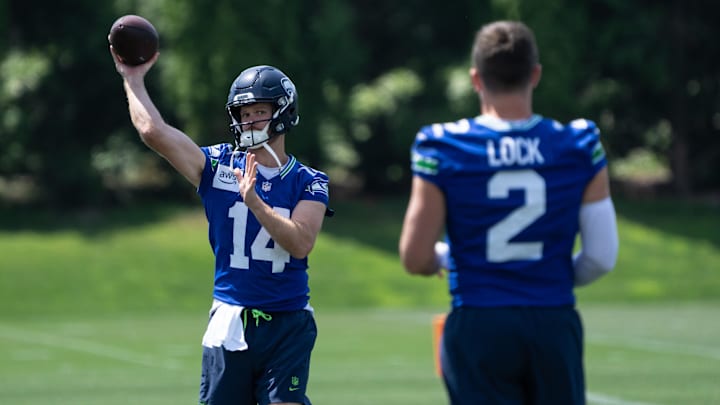 Jun 11, 2025; Renton, WA, USA; Seattle Seahawks quarterback Sam Darnold (14) passes the ball to quarterback Drew Lock (2) during mini-camp at Virginia Mason Athletic Center. Mandatory Credit: Stephen Brashear-Imagn Images