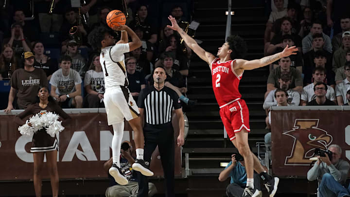 Mar 11, 2026; Bethlehem, Pennsylvania, USA; Lehigh Mountain Hawks guard Nasir Whitlock (1) shoots as Boston University Terriers guard Chance Gladden (2) defends.