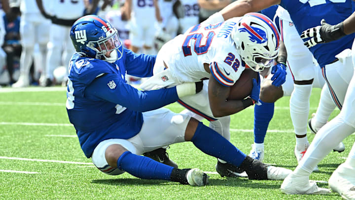 Aug 9, 2025; Orchard Park, New York, USA; New York Giants defensive tackle Cory Durden (69) makes a tackle on Buffalo Bills running back Ray Davis (22) in the second quarter at Highmark Stadium