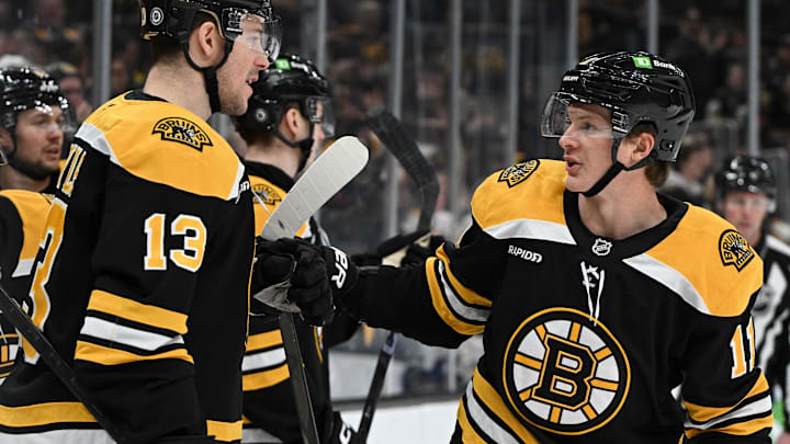 Jan 14, 2025; Boston, Massachusetts, USA; Boston Bruins center Trent Frederic (11) celebrates with center Charlie Coyle (13) after scoring a goal against the Tampa Bay Lightning during the first period at the TD Garden. Mandatory Credit: Brian Fluharty-Imagn Images