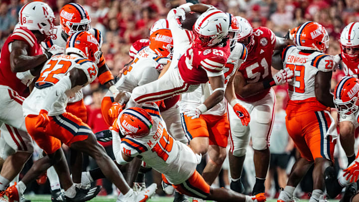 Sep 20, 2024; Lincoln, Nebraska, USA; Nebraska Cornhuskers running back Dante Dowdell (23) is brought down by Illinois Fighting Illini defensive back Miles Scott (10) during the fourth quarter at Memorial Stadium. Mandatory Credit: Dylan Widger-Imagn Images