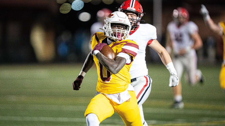 Ankeny's Daniel Larmie (0) runs the ball for a big gain against Linn-Mar on Friday, Nov. 1, 2024, at Ankeny Stadium.