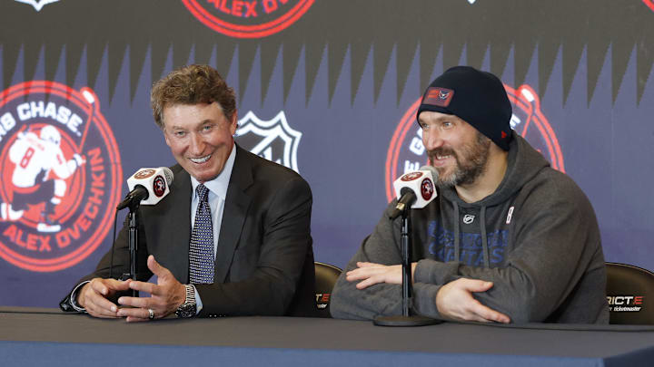 Apr 4, 2025; Washington, District of Columbia, USA; Washington Capitals left wing Alex Ovechkin (right) speaks at a press conference with Wayne Gretzky after the game against the Chicago Blackhawks at Capital One Arena. Ovechkin scored the 893rd and 894th goals of his career, tying Gretzky for most all-time goals in NHL history. Mandatory Credit: Geoff Burke-Imagn Images