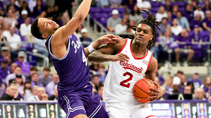 Feb 24, 2024; Fort Worth, Texas, USA; Cincinnati Bearcats guard Jizzle James (2) drives to the basket as TCU Horned Frogs guard Jameer Nelson Jr. (4) defends during the second half at Ed and Rae Schollmaier Arena. Mandatory Credit: Kevin Jairaj-Imagn Images