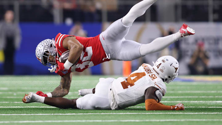 Jan 10, 2025; Arlington, Texas, USA; Texas Longhorns defensive back Andrew Mukuba (4) tackles Ohio State Buckeyes running back TreVeyon Henderson (32) during the third quarter of the College Football Playoff semifinal in the Cotton Bowl Jan 10, 2025; Arlington, Texas, USA; Texas Longhorns defensive back Andrew Mukuba (4) tackles Ohio State Buckeyes running back TreVeyon Henderson (32) during the third quarter of the College Football Playoff semifinal in the Cotton Bowl