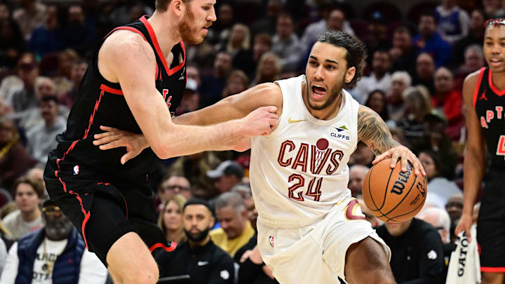 Nov 24, 2024; Cleveland, Ohio, USA; Cleveland Cavaliers forward Jaylon Tyson (24) drives to the basket against Toronto Raptors center Jakob Poeltl (19) during the first half at Rocket Mortgage FieldHouse. Mandatory Credit: Ken Blaze-Imagn Images