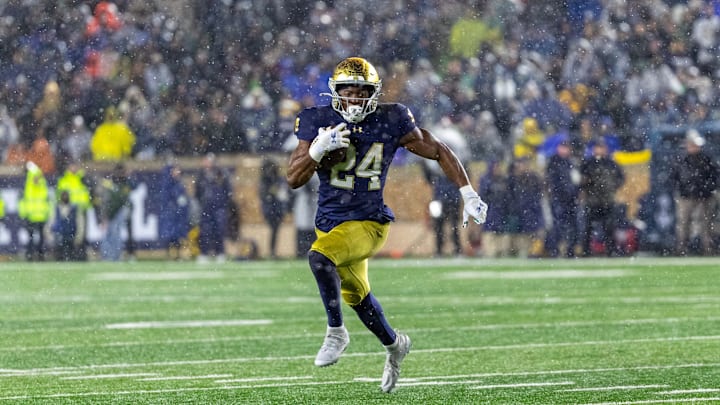 Nov 8, 2025; South Bend, Indiana, USA; Notre Dame Fighting Irish running back Jadarian Price (24) runs the ball against the Navy Midshipmen during the second half at Notre Dame Stadium. 