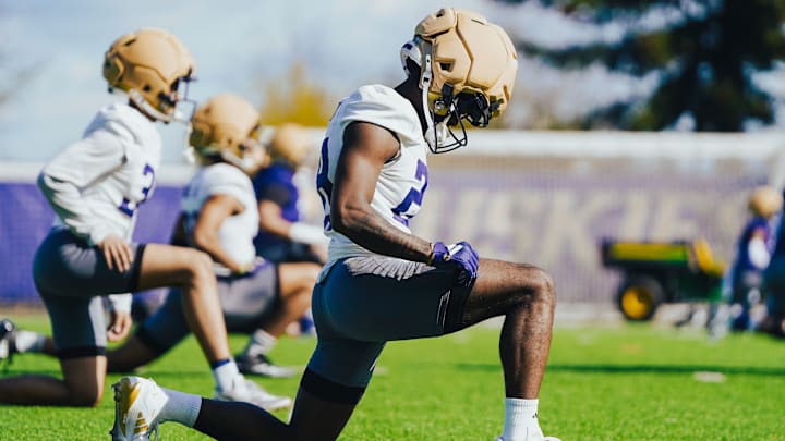 D'Aryhian Clemons stretches out during a UW spring practice. 