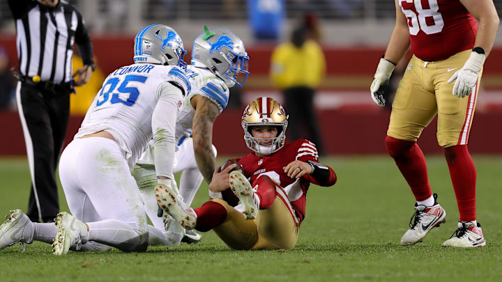 San Francisco 49ers quarterback Brock Purdy (13) is sacked by Detroit Lions safety Brian Branch (32) during the fourth quarter at Levi's Stadium.